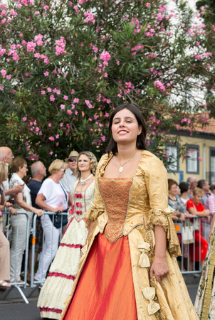 FUNCHAL, MADEIRA, PORTUGAL - SEPTEMBER 4, 2016:  Woman in historical fashion dress durnig historical and ethnographic  parade of Madeira Wine Festival in Funchal. Madeira, Portugalのeditorial素材