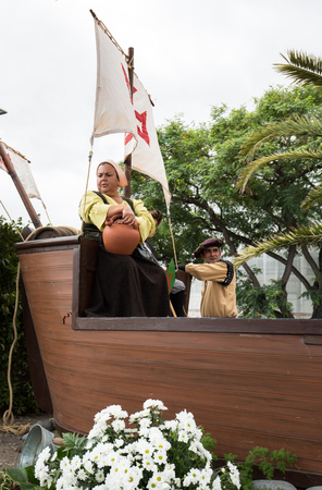 FUNCHAL, PORTUGAL - SEPTEMBER 4, 2016: Group of people in traditional costume  durnig historical and ethnographic  parade of Madeira Wine Festival in Funchal. Madeira, Portugalのeditorial素材