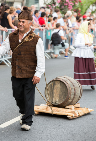 FUNCHAL, PORTUGAL - SEPTEMBER 4, 2016: Group of people in traditional costume  durnig historical and ethnographic  parade of Madeira Wine Festival in Funchal. Madeira, Portugallのeditorial素材