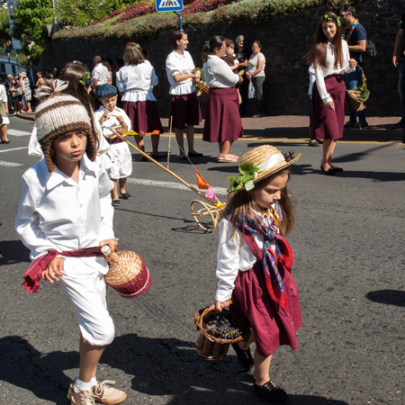 ESTREITO DE CAMARA DE LOBOS, PORTUGAL - SEPTEMBER 10, 2016: People wearing in traditional costumes at Madeira Wine Festival in Estreito de Camara de Lobos, Madeira, Portugal.のeditorial素材