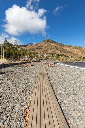 MACHICO, MADEIRA, PORTUGAL - SEPTEMBER 11, 2016: People are resting on a sunny day at the beach in Machico. Madeira Island, Portugalのeditorial素材