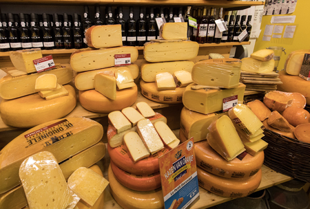 ALKMAAR, NETHERLANDS - APRIL 21, 2017: Display of traditional Dutch cheese, like Edam and Gouda cheese  at local cheese shop, Alkmaar, the Netherlandsのeditorial素材