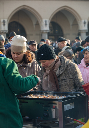 Cracow, Poland - december 17, 2017:   Christmas Eve for poor and homeless on the Main Square in Cracow. Every year the group Kosciuszko prepares the greatest eve in the open air in Polandのeditorial素材