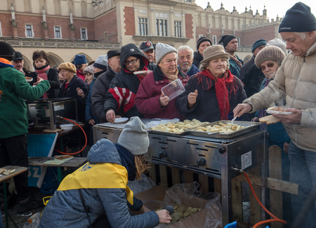 Cracow, Poland - december 17, 2017:   Christmas Eve for poor and homeless on the Main Square in Cracow. Every year the group Kosciuszko prepares the greatest eve in the open air in Polandのeditorial素材