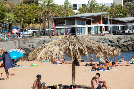 MACHICO, MADEIRA, PORTUGAL - SEPTEMBER 11, 2016: People are resting on a sunny day at the beach in Machico. Madeira Island, Portugaのeditorial素材
