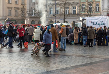Cracow, Poland - December 17, 2017:   Christmas Eve for poor and homeless on the Main Square in Cracow. Every year the group Kosciuszko prepares the greatest eve in the open air in Cracow. Polandのeditorial素材