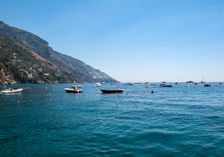 Positano, Italy - June 13, 2017: Fishing boats and yachts moored in Tyrrhenian Sea near Positano, Amalfi Coast. Italy のeditorial素材