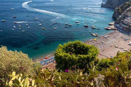 Positano, Italy - June 12, 2017: The main beach in Positano, Spiaggia Grande, with its bright orange and blue beach umbrellas and the sparkling blue sea of the Amalfi Coast.のeditorial素材