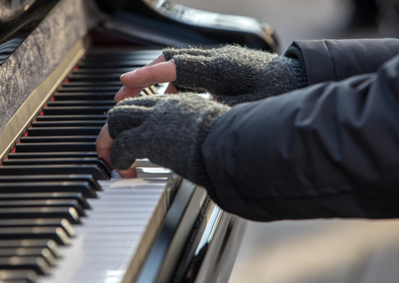 The pianist plays the piano outside in winterの写真素材