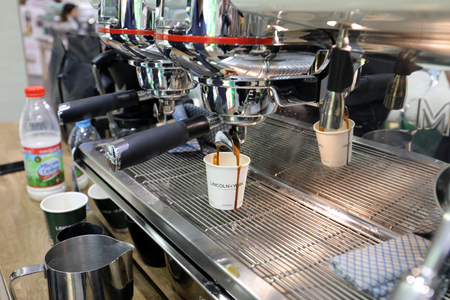 Cracow, Poland - November 16, 2017:  Barista making coffee at coffee machine at Gastrofood - Trade Fair for Food and Drinks for Catering in Cracow. Polandのeditorial素材