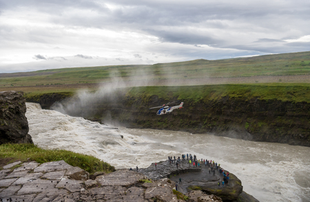 Gullfoss Waterfall, Iceland - July 19, 2017:  Helicopter over the canyon of Hvita river on a cloudy day. Icelandのeditorial素材