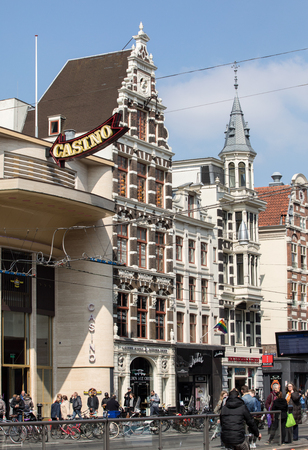 AMSTERDAM, NETHERLANDS - APRIL 20, 2017: Damrak main street crowded with tourists in Amsterdam, Netherlands のeditorial素材
