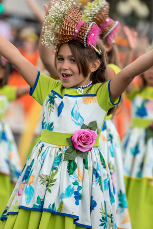 Funchal; Madeira; Portugal - April 22; 2018: A group of girls in colorful costumes are dancing at Madeira Flower Festival Parade in Funchal on the Island of Madeira. Portugal.のeditorial素材