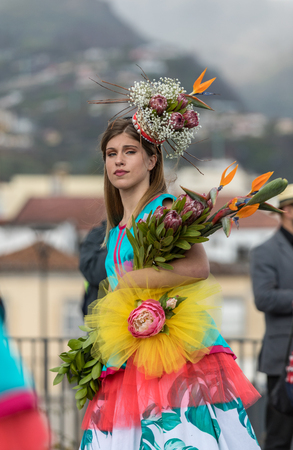 Funchal; Madeira; Portugal - April 22; 2018: Girl in a colorful costume at the Madeira Flower Festival Parade , Funchal, Madeira, Portugalのeditorial素材