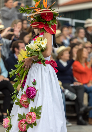 Funchal; Madeira; Portugal - April 22; 2018: Woman in a colorful costume at the Madeira Flower Festival Parade , Funchal, Madeira, Portugalのeditorial素材
