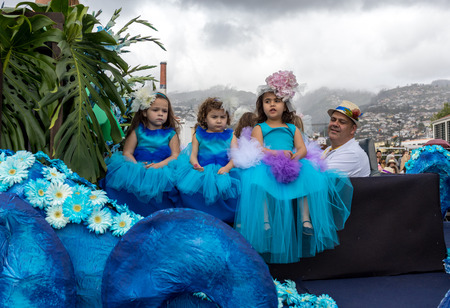 Funchal; Madeira; Portugal - April 22; 2018: Children in colorful costumes on the floral float at Madeira Flower Festival Parade in Funchal on the Island of Madeira. Portugal.のeditorial素材