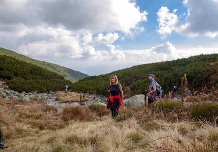 Vysoke Tatry, Slovakia - October 9, 2018: Hikers on trail at Great Cold Valley,  Vysoke Tatry (High Tatras), Slovakia. The Great Cold Valley is 7 km long valley, very attractive for touristsのeditorial素材