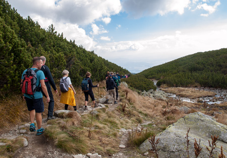 Vysoke Tatry, Slovakia - October 9, 2018: Hikers on trail at Great Cold Valley,  Vysoke Tatry (High Tatras), Slovakia. The Great Cold Valley is 7 km long valley, very attractive for touristsのeditorial素材