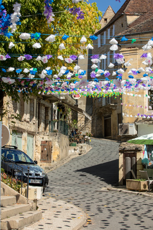 Saint Cyprien, France - September 4, 2018: Colourful street decorations during the summer Felibree in Saint Cyprien, France. A felibree is a traditional Occitan festival which takes place every year in a town or village in the Dordogne.のeditorial素材