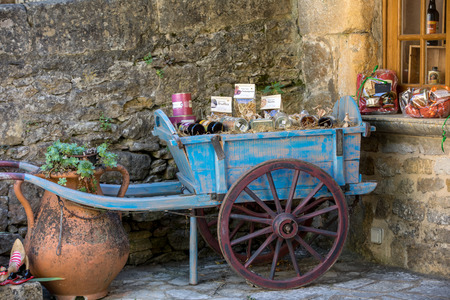 Beynac et Cazenac, France - September 4, 2018: Old wooden blue  cart full of local product for sale in Benyac. Franceのeditorial素材
