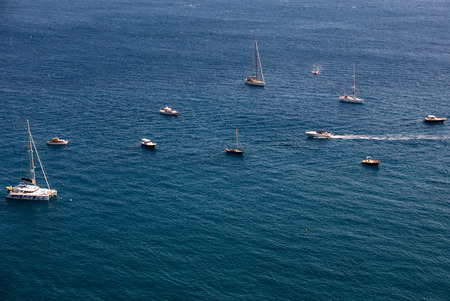 Positano, Italy - June 12, 2017: Fishing boats and yachts moored in Tyrrhenian Sea near Positano, Amalfi Coast. Italyのeditorial素材