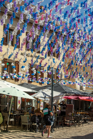 Saint Cyprien, France - September 4, 2018: Colourful street decorations during the summer Felibree in Saint Cyprien, France. A felibree is a traditional Occitan festival which takes place every year in a town or village in the Dordogne.のeditorial素材