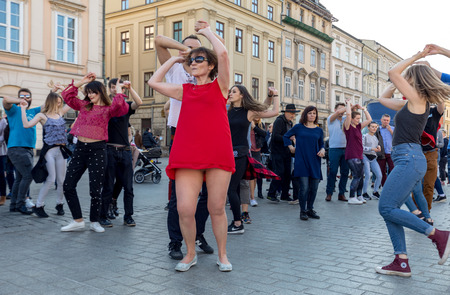 Cracow, Poland - Maerch 30, 2019:  International Flashmob Day of Rueda de Casino. Several hundred persons dance Hispanic rhythms on the Main Square in Cracow. Polandのeditorial素材