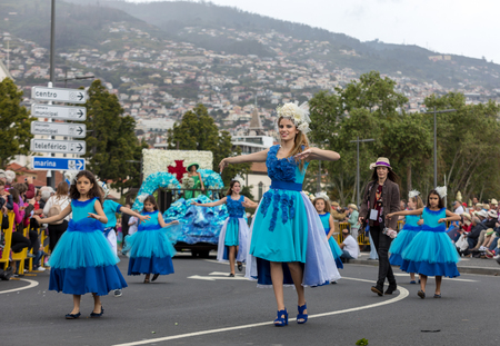 Funchal; Madeira; Portugal - April 22; 2018: A group of people in colorful costumes are dancing at Madeira Flower Festival Parade in Funchal on the Island of Madeira. Portugal.のeditorial素材