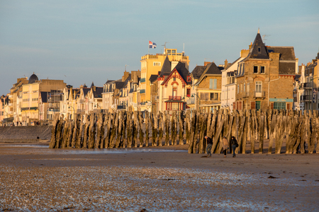 St Malo, France - September 15, 2018: Beach in the evening sun and buildings along the seafront promenade in Saint Malo. Brittany, Franceのeditorial素材
