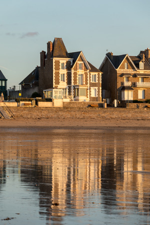 St Malo, France - September 14, 2018: Beach in the evening sun and buildings along the seafront promenade in Saint Malo. Brittany, Franceのeditorial素材
