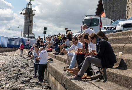Cancale, France - September 15, 2018: People eating oysters bought on the seafront at Cancale, Brittany, Franceのeditorial素材