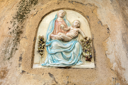 Ceramic bas-relief of the Virgin Mary with Jesus on the wall of the house in Ravello. Amalfi Coast. Italyの写真素材