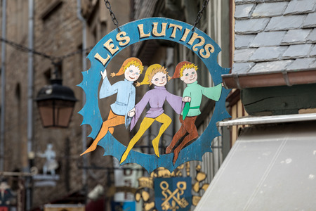 Le Mont-Saint-Michel, France - September 13, 2018: Artistically stylized advertising of restaurants and shops on the Grand Rue, the main street in Mont Saint Michele. Normandy, Franceのeditorial素材