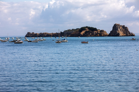Cancale, France - September 15, 2018: Fishing boats and yachts moored in the bay at high tide in Cancale, famous oysters production town. Brittany, France,のeditorial素材