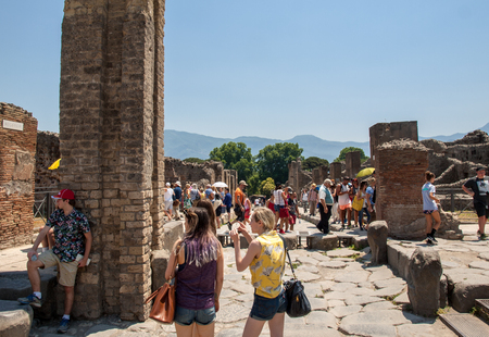 Pompeii, Italy - June 15, 2017:  The famous archaeological site of Pompeii UNESCO heritage. Crowd of tourists under the scorching sun.のeditorial素材