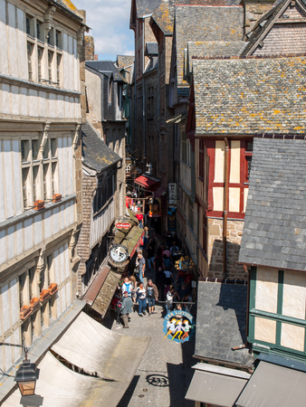 Le Mont-Saint-Michel, France - September 13, 2018: A crowd of tourists on Grand Rue, the main street in Mont Saint Michele. Normandy, Franceのeditorial素材