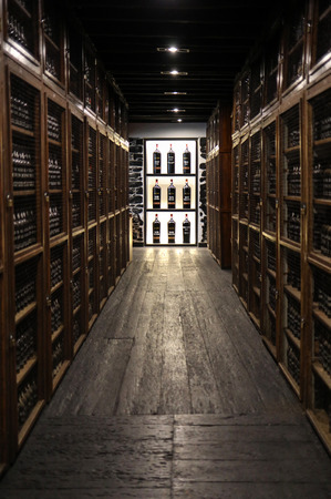 Funchal, Madeira, Portugal - April 23, 2018: Museum - repository of expensive vintage wine Madera. Long rows of shelves made of bottles of wine. funchal, Madera. Portugalのeditorial素材