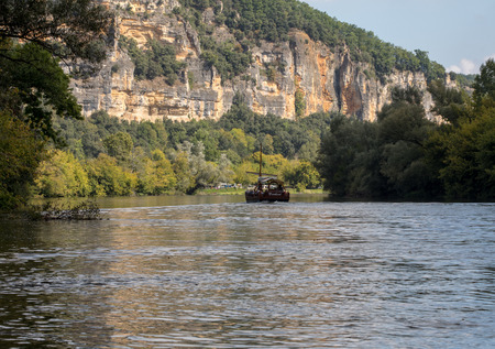 La Roque-Gageac, Dordogne, France - September 7, 2018: A tourist boat, in French called gabare, on the river Dordogne at La Roque-Gageac, Aquitaine, Franceのeditorial素材