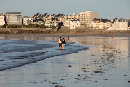 St Malo, France - September 16, 2018: Romantic walk of people before sunset on the picturesque beach of Saint Malo. Brittany, Franceのeditorial素材