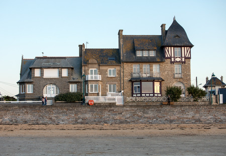St Malo, France - September 15, 2018: Beach in the evening sun and buildings along the seafront promenade in Saint Malo. Brittany, Franceのeditorial素材