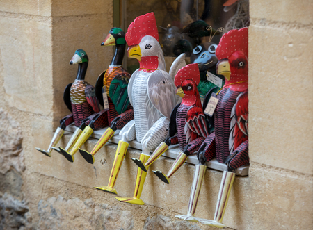 Sarlat la Caneda , France - September 4, 2018: Colorful wooden geese and roosters in the gift shop in Sarlat la Caneda. Perigord,  Franceのeditorial素材