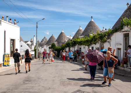 Alberobello, Italy - Septembet 16, 2019:  People visit Trulli village in Alberobello, Italy. The style of construction is specific to the Murge area of the Italian region of Apulia (in Italian Puglia). Made of limestone and keystone.のeditorial素材