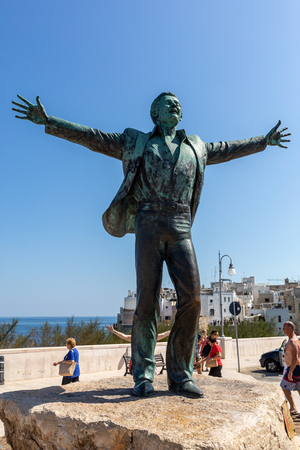 Polignano a Mare, Italy - Sept 17, 2019: Statue of the Italian singer and songwriter Domenico Modugno famous for the song Volare was born in Polignano a Mare. Italy. The author of the sculpture is Herman Mejerのeditorial素材