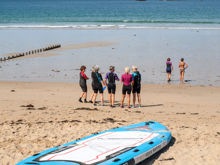 Saint-Malo, France - September 14, 2018: Group of women going for a morning aqua walking along the beach in Saint Malo. Brittany, Franceのeditorial素材