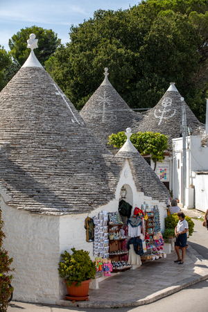 Alberobello, Italy - September 16, 2019:  People visit Trulli village in Alberobello, Italy. The style of construction is specific to the Murge area of the Italian region of Apulia (in Italian Puglia). Made of limestone and keystone.のeditorial素材