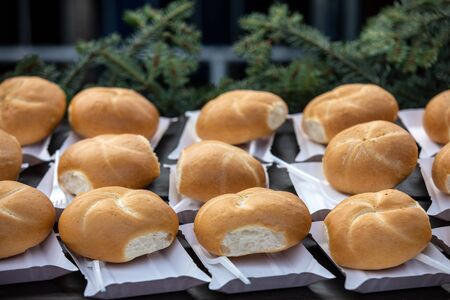 freshly baked rolls on paper trays ready to eatの写真素材