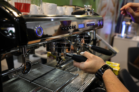Cracow, Poland - November 20, 2019:  Barista making coffee at coffee machine at Gastrofood - Trade Fair for Food and Drinks for Catering in Cracow. Polandのeditorial素材