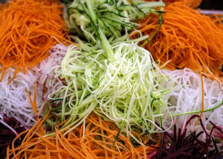 Different raw shredded vegetables and fruits as an example of a healthy dietの写真素材