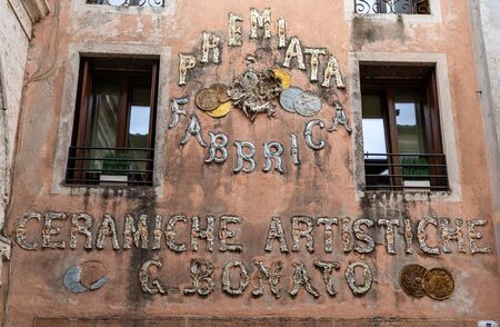 Bassano del Grappa, Italy  - September 6, 2019: Sign on the facade of an old ceramic factory n Bassano del Grappa. Italyのeditorial素材