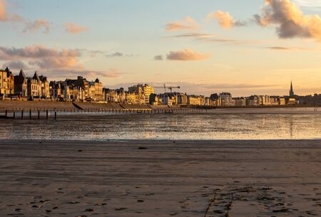 St Malo, France - September 14, 2018: Beach in the evening sun and buildings along the seafront promenade in Saint Malo. Brittany, Franceのeditorial素材